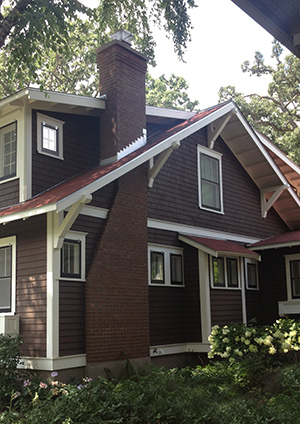 Side view of a brown house with a completed ground up chimney rebuild