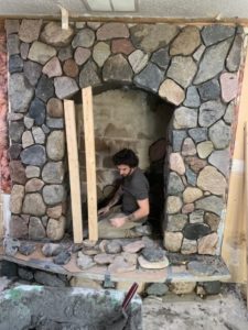 Masonry Expert Jordan Re-modeling Fireplace In River Rock Image